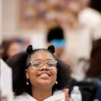 Girls of Color Summit previous event and a kid smiling for a photo